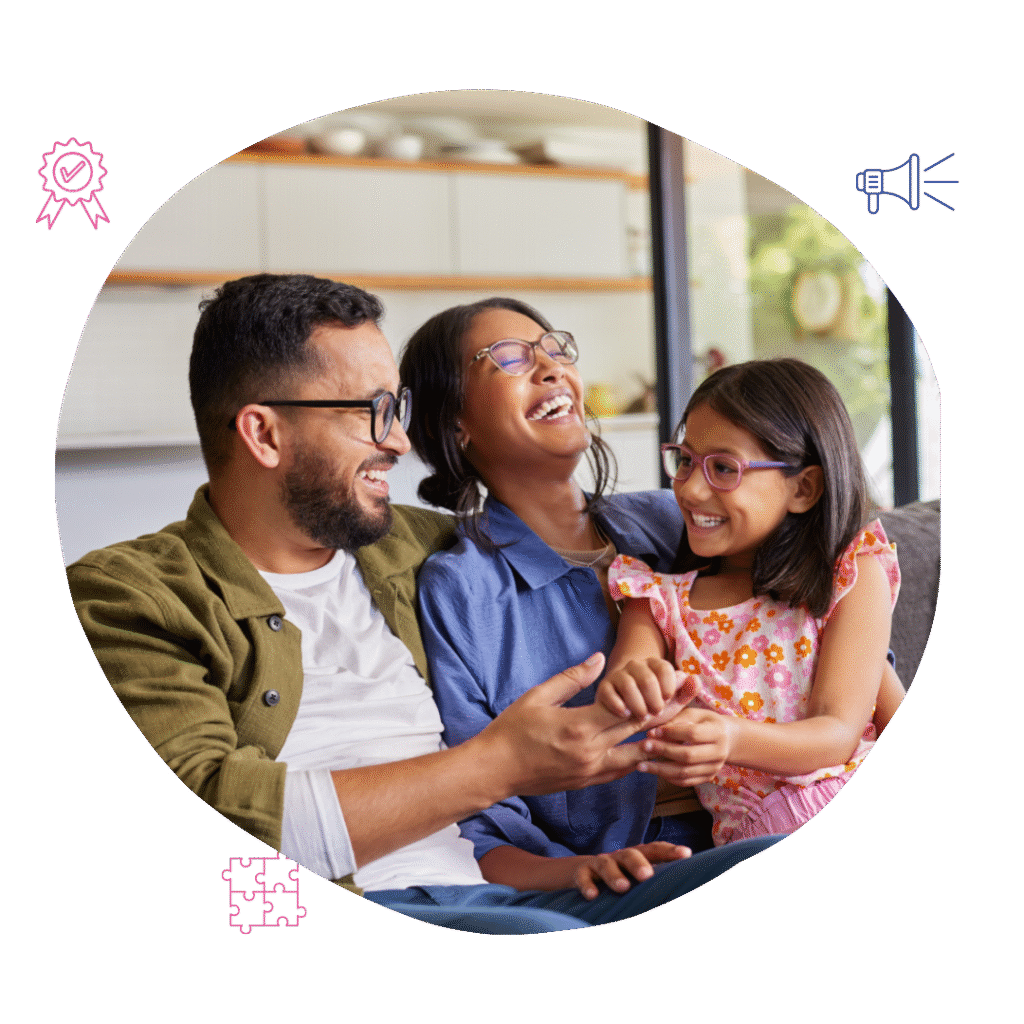 A smiling family, father, mother, and daughter, laughing together on a couch, demonstrating Your Best Life Behaviour Support